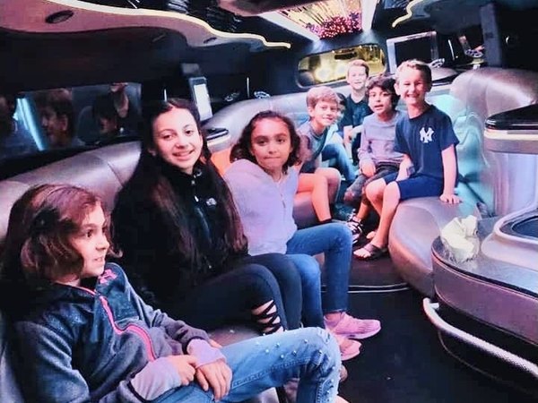 Passengers seated inside the white Hummer H2 stretch limousine — Ballantyne Limousine, Charlotte NC