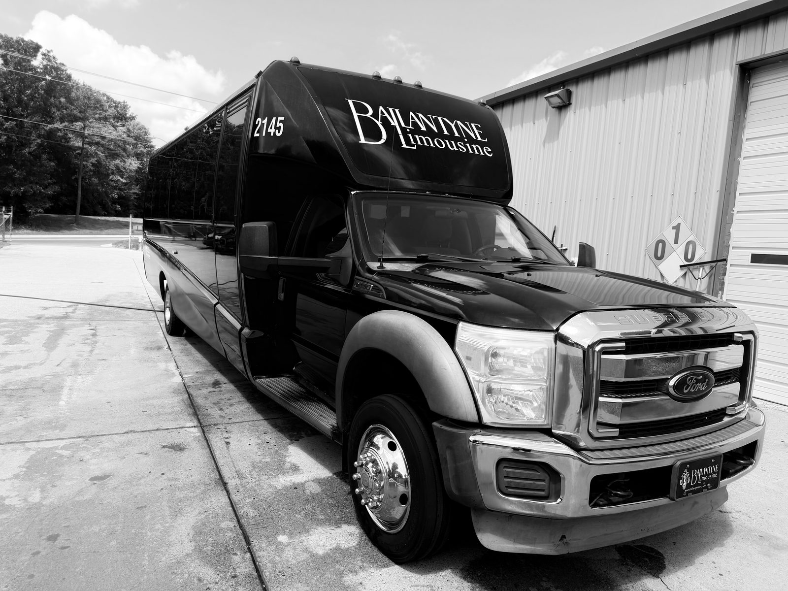 Black Limo Executive Bus exterior with Ballantyne Limousine roof lettering — Charlotte NC chauffeured limo bus