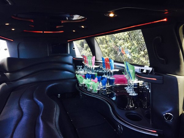 Lincoln Stretch Limousine interior — leather bench seating and stocked bar, Ballantyne Limousine, Charlotte NC